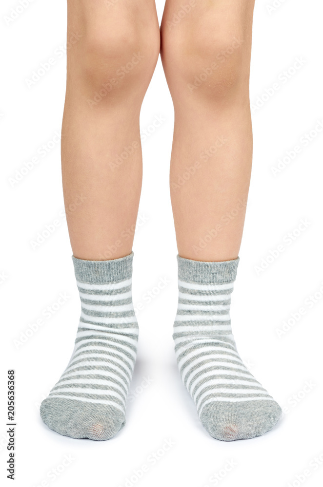 Kid legs in striped socks isolated on white background