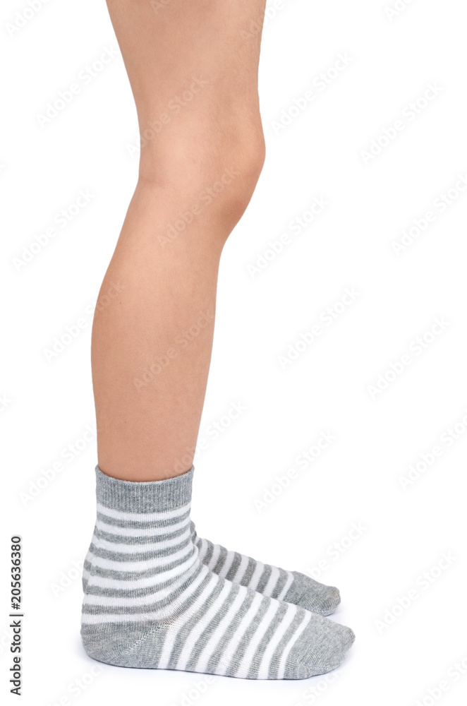 Kid legs in striped socks isolated on white background
