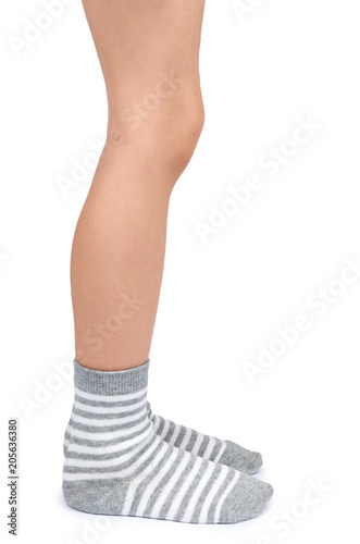 Kid legs in striped socks isolated on white background © Sviatoslav Kovtun