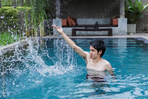 man in swimming pool and playing water splash © geargodz