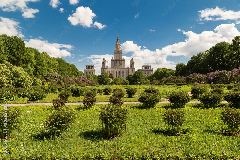 View of the Building of Moscow State University in the summer. The blossoming gardens of a lilac and an apple-tree. Soft focus
