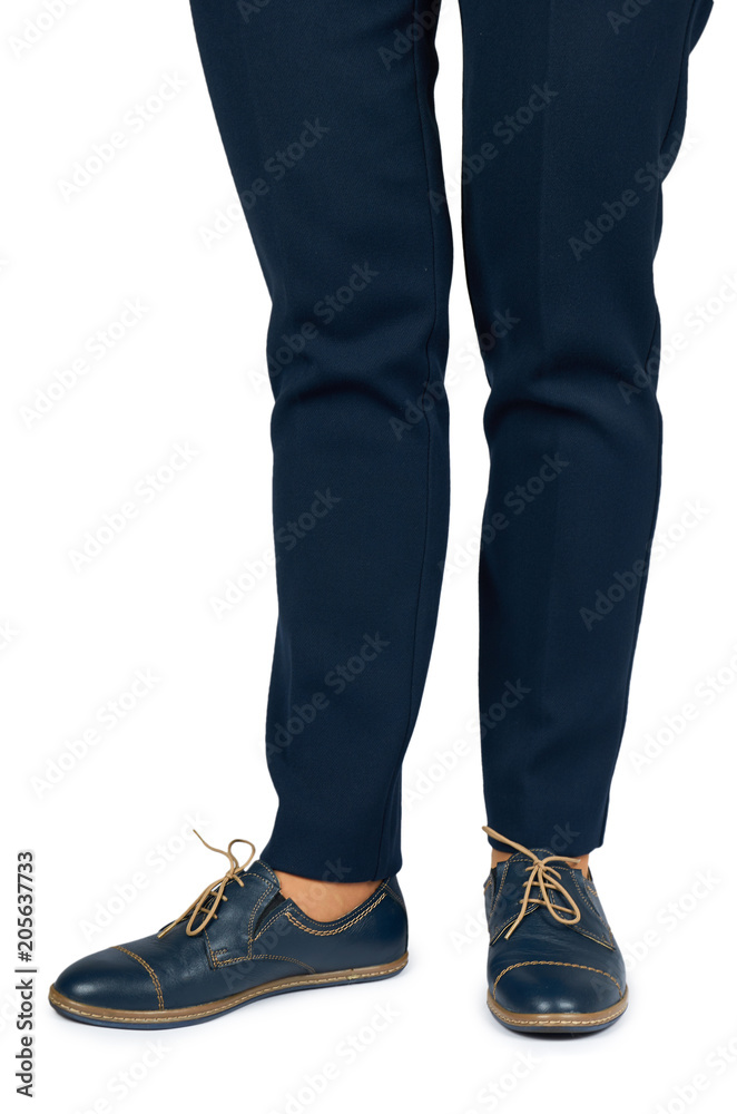 Female leg in pants and leather shoes isolated on white background