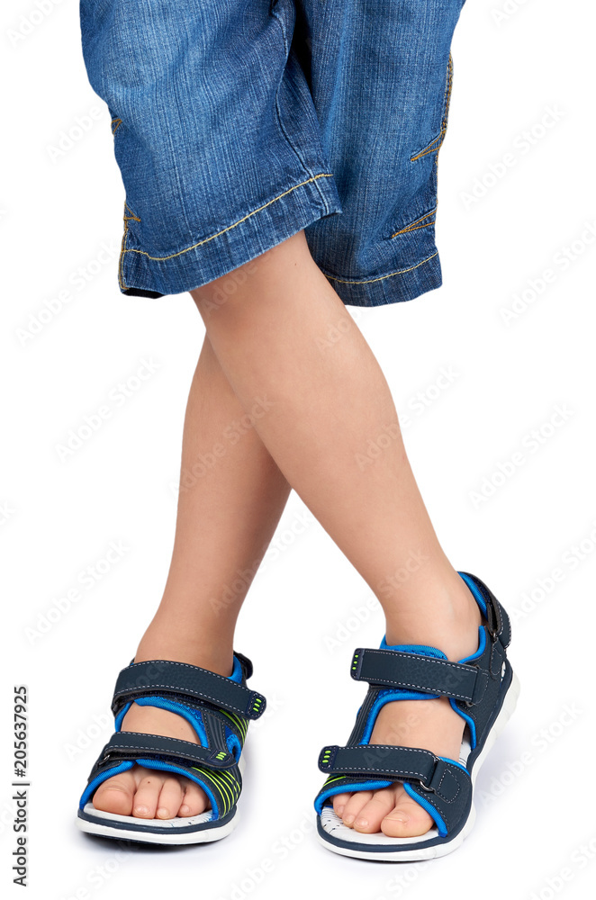Kids leather sandals on leg isolated on a white background