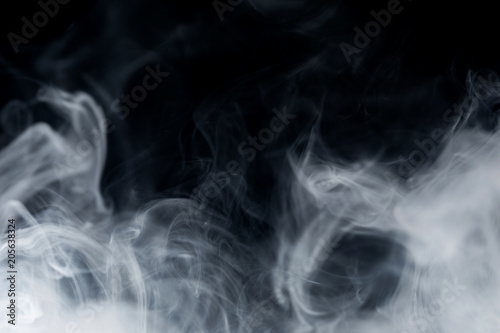 Make smoke from incense. Black background