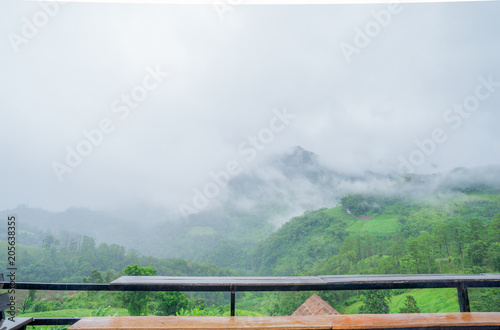 Patio and chair wood Mountain View in Asia, Doi Luang Chiang Dao Chiang Mai Thailand After rain, there is a fog float, covered with green forest, mountain air fresh air landscape nature concept