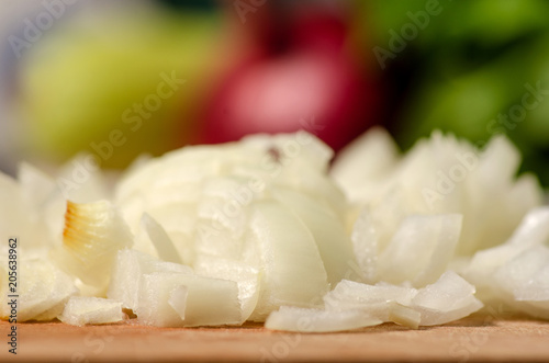 Sliced onions on a wooden board vegetable blur background