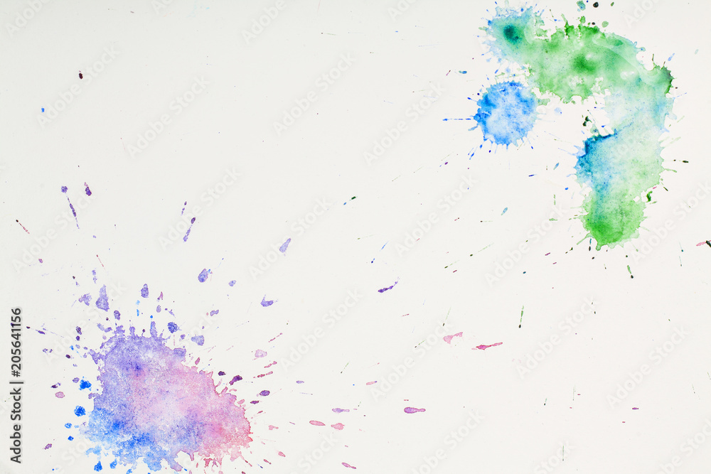 colored watercolor blots on paper on white background