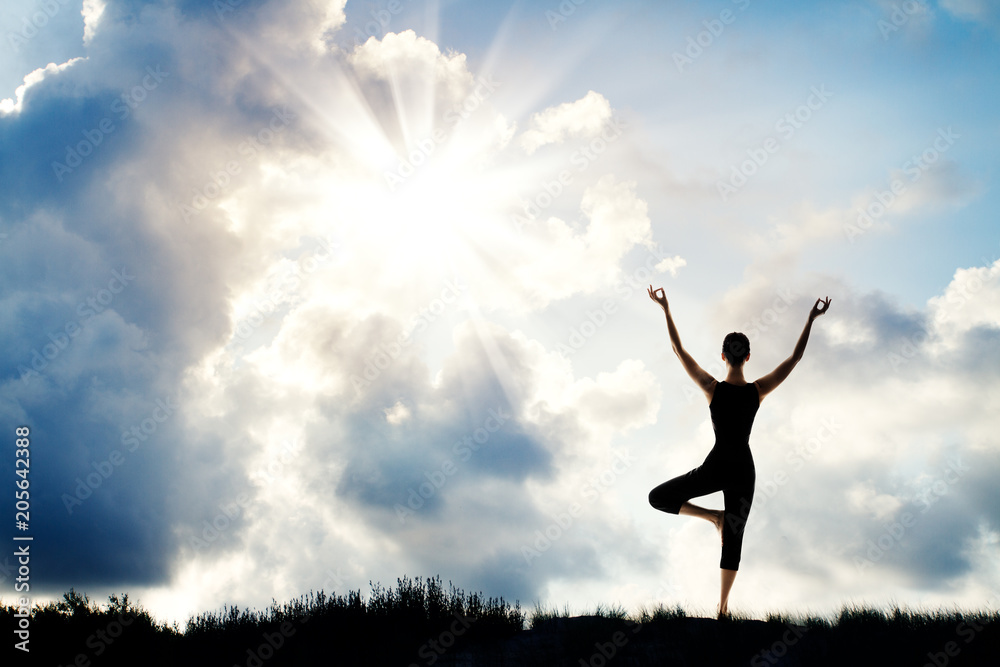 Yoga Meditation, Woman Stand with Raised Arms in Nature, Human Meditating over Sun Sky Background Yoga Meditation, Woman Stand with Raised Arms in Nature, Human Meditating over Sun Sky Background