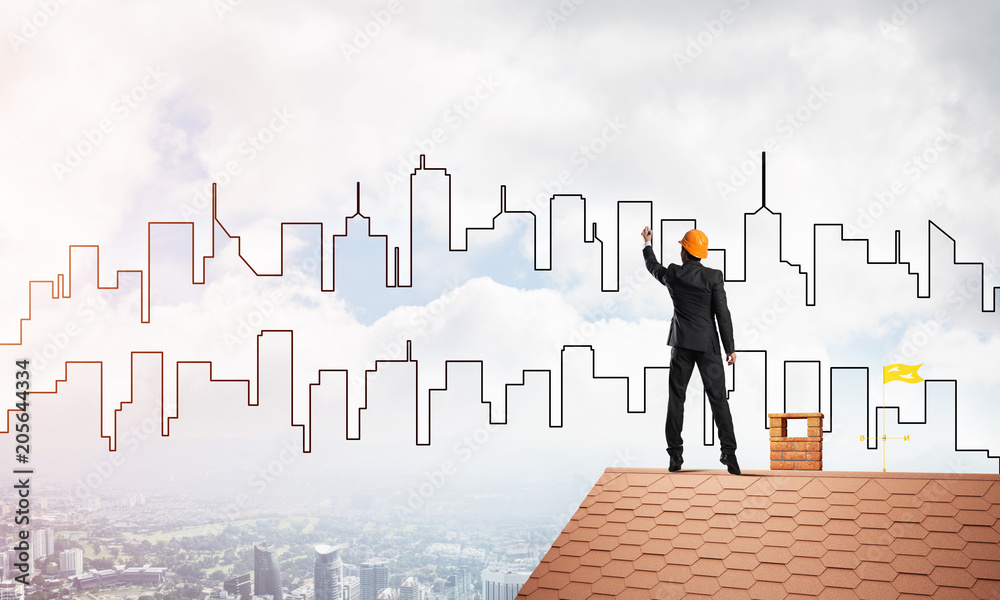 Man architect draw silhouette of modern city on blue sky. Mixed media Man architect draw silhouette of modern city on blue sky. Mixed media