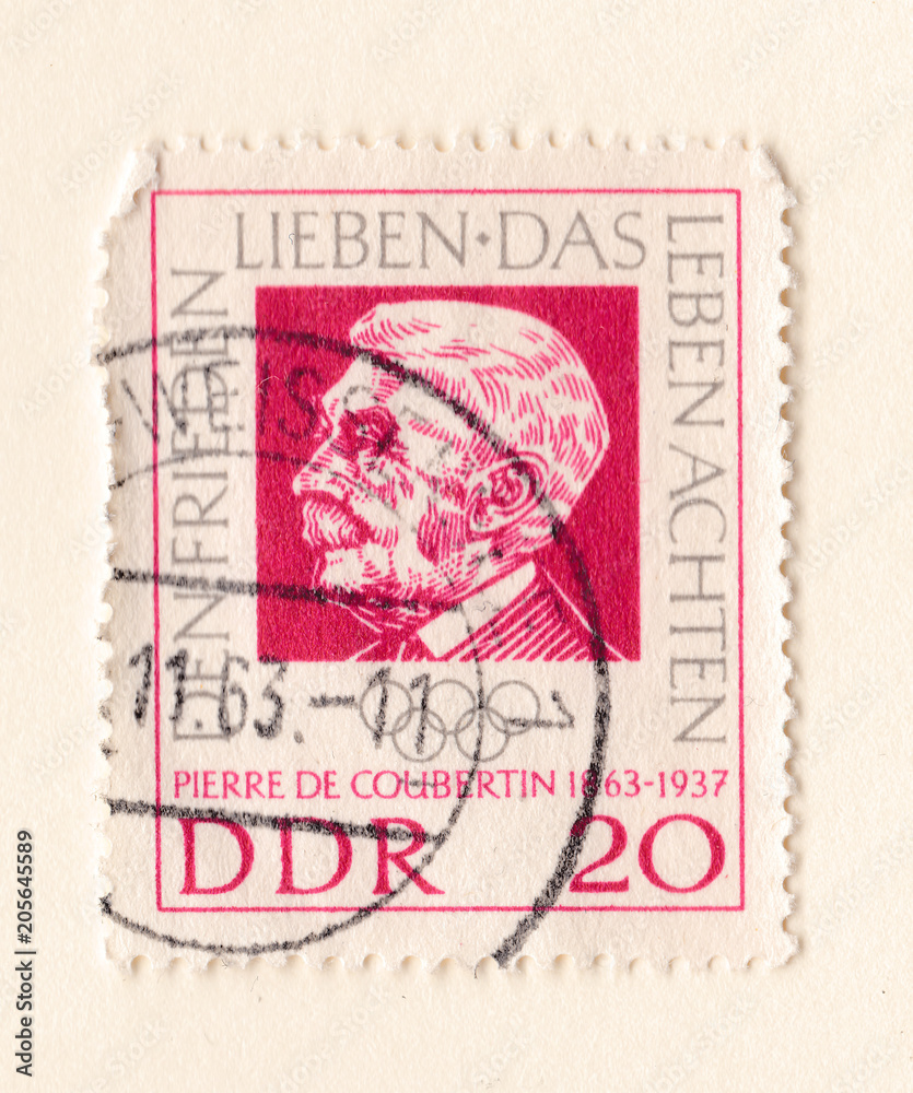 An old red east german stamp with an image of Baron Pierre de Coubertin founder of the International Olympic Committee