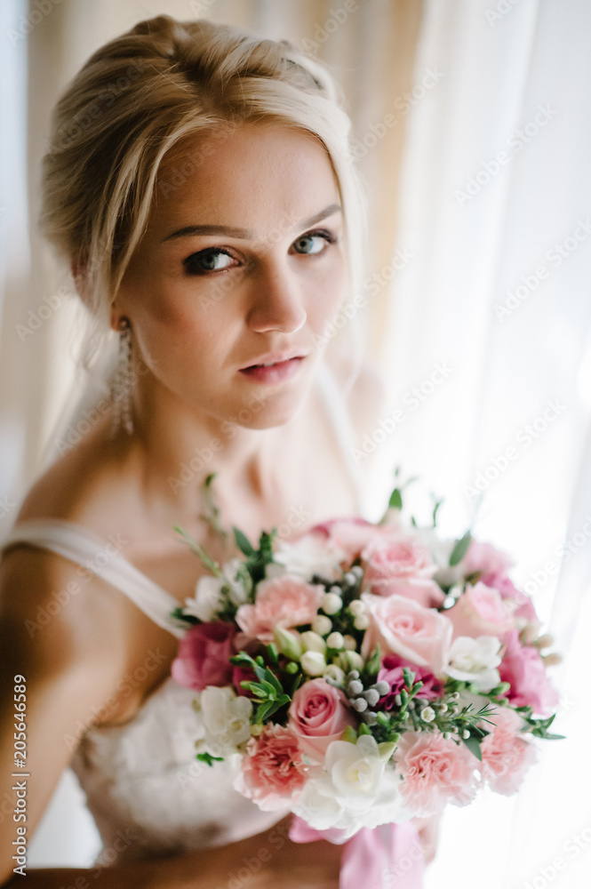 Young attractive bride with bouquet flowers.