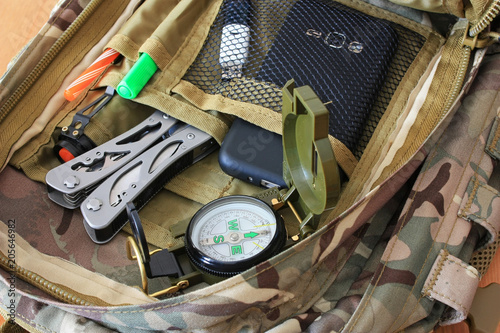 Compass, multitool in a backpack photo