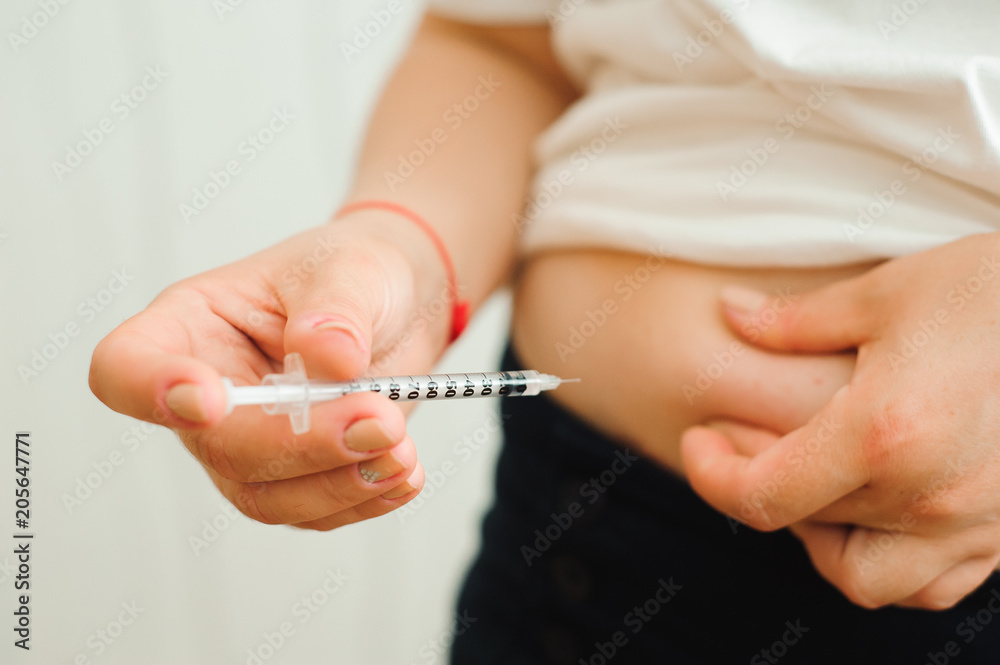 medicine, diabetes, glycemia, health care and people concept - close up of woman hands making injection with insulin pen or syringe medicine, diabetes, glycemia, health care and people concept - close up of woman hands making injection with insulin pen or syringe