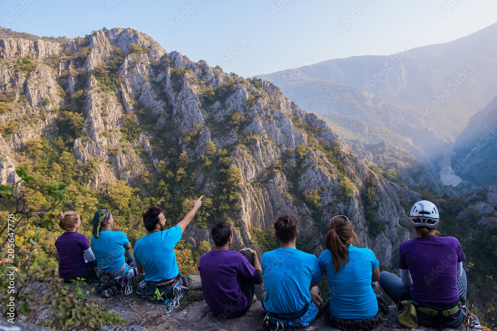 Group of mountaineers sitting on peak