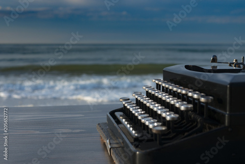 typewriter on the background of the sea at dawn. summer beach