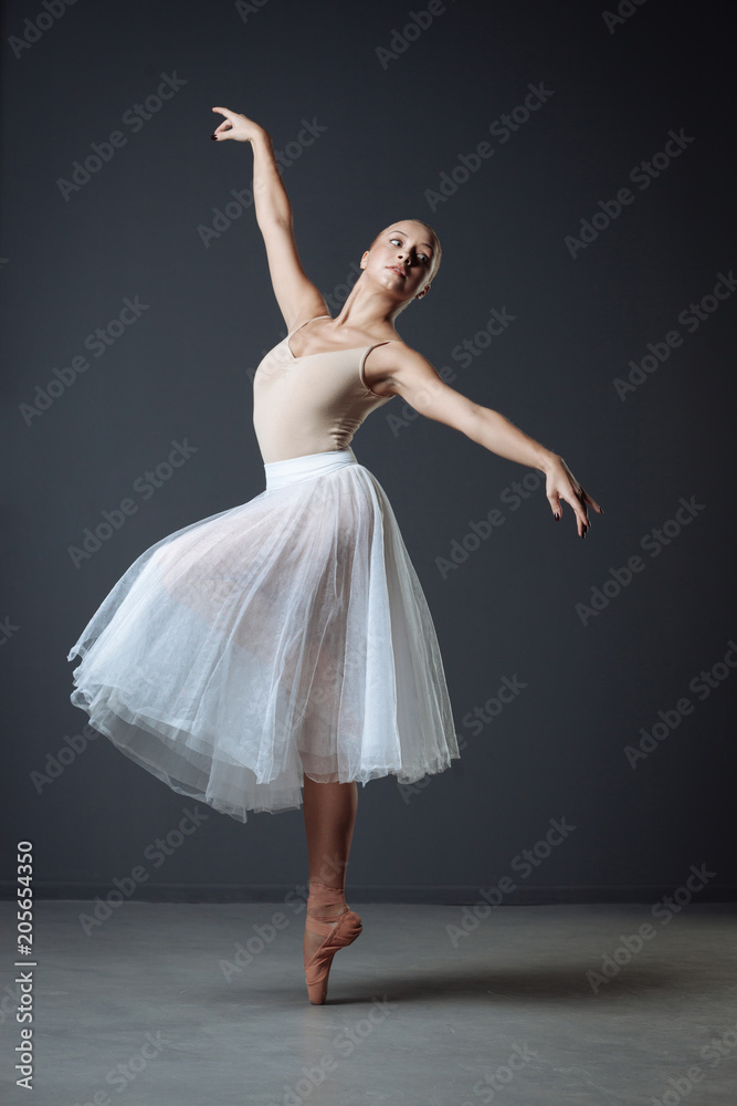 Elegant graceful dancer standing and holding hand gracefully Elegant graceful dancer standing and holding hand gracefully