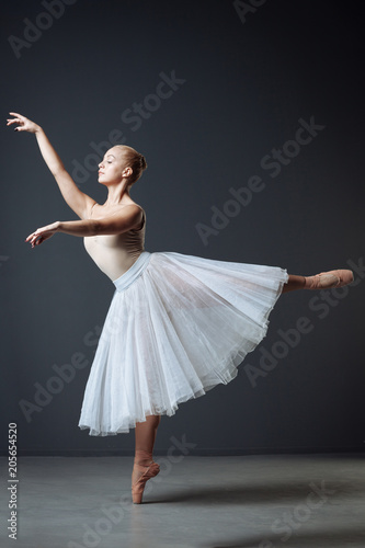Cute flexible dancer standing an doing elegant movements.