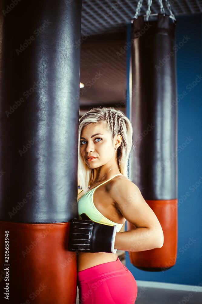 girl boxer beats the punching bag