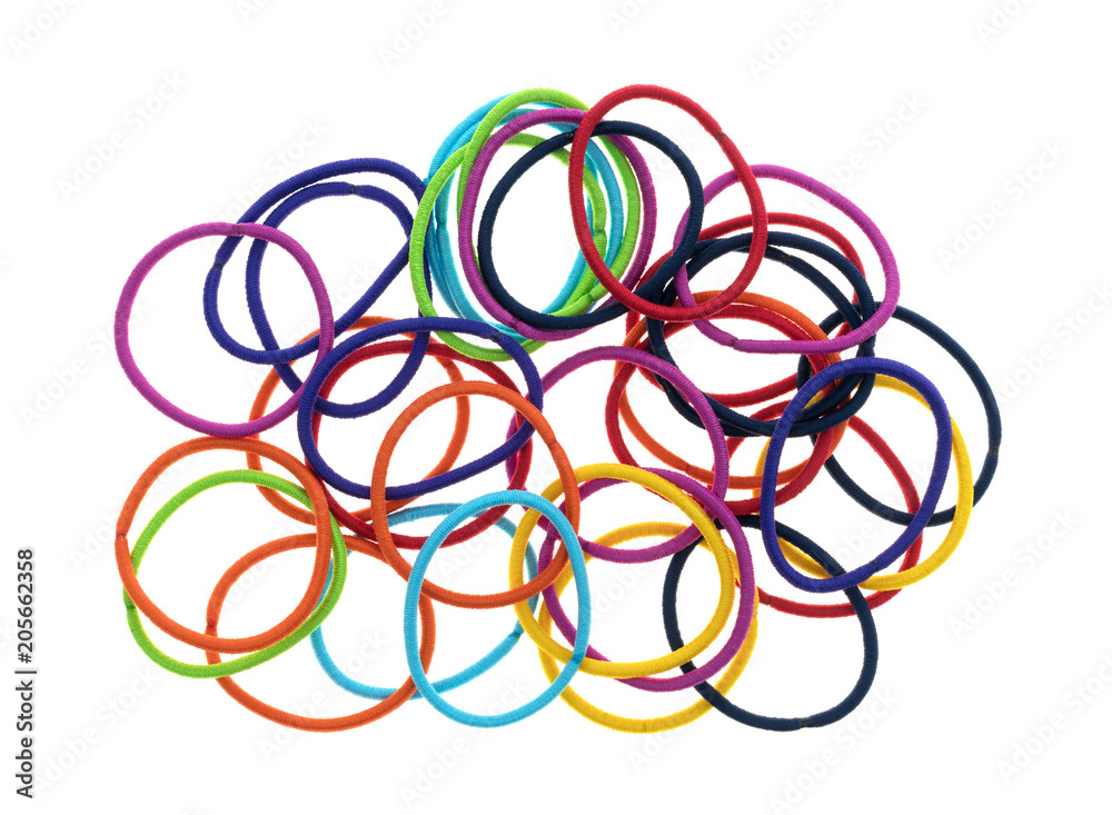 Top view of a large group of ponytail holders on a white background.