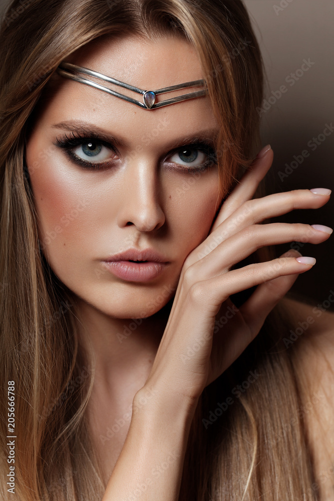A portrait of a young glamorous woman wearing stylish modern tiara A portrait of a young glamorous woman wearing stylish modern tiara