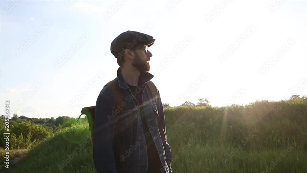 Traveler Walking a Hills. Hipster Walking on fields Traveler Walking a Hills. Hipster Walking on fields