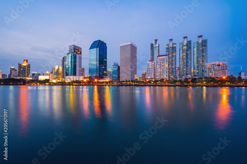 Bangkok city downtown at twilight with reflection of skyline  Benjakiti Park  Bangkok Thailand