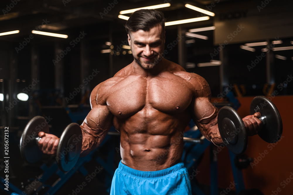 Fototapeta premium Handsome model muscle man abs workout in gym