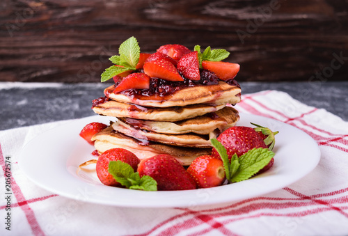Fototapeta Naklejka Na Ścianę i Meble -  American pancakes with jam and fresh strawberries