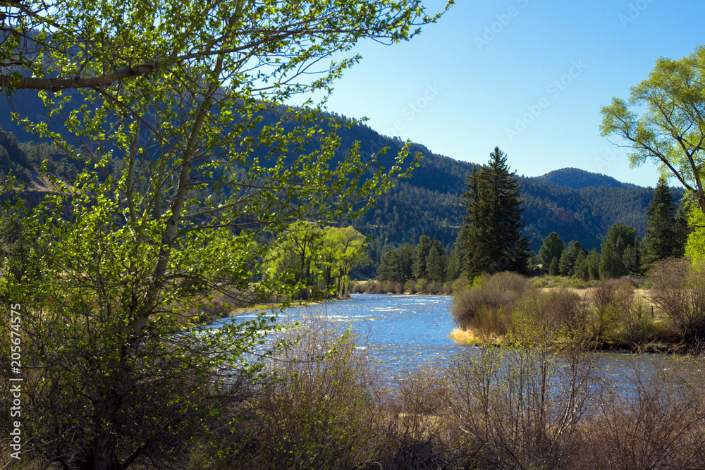 The Río Grande, aspens, cottonwoods, and pines, the Coller State Wildlife Area, and the San Juan Mountains line the road to Creede in southern Colorado The Río Grande, aspens, cottonwoods, and pines, the Coller State Wildlife Area, and the San Juan Mountains line the road to Creede in southern Colorado