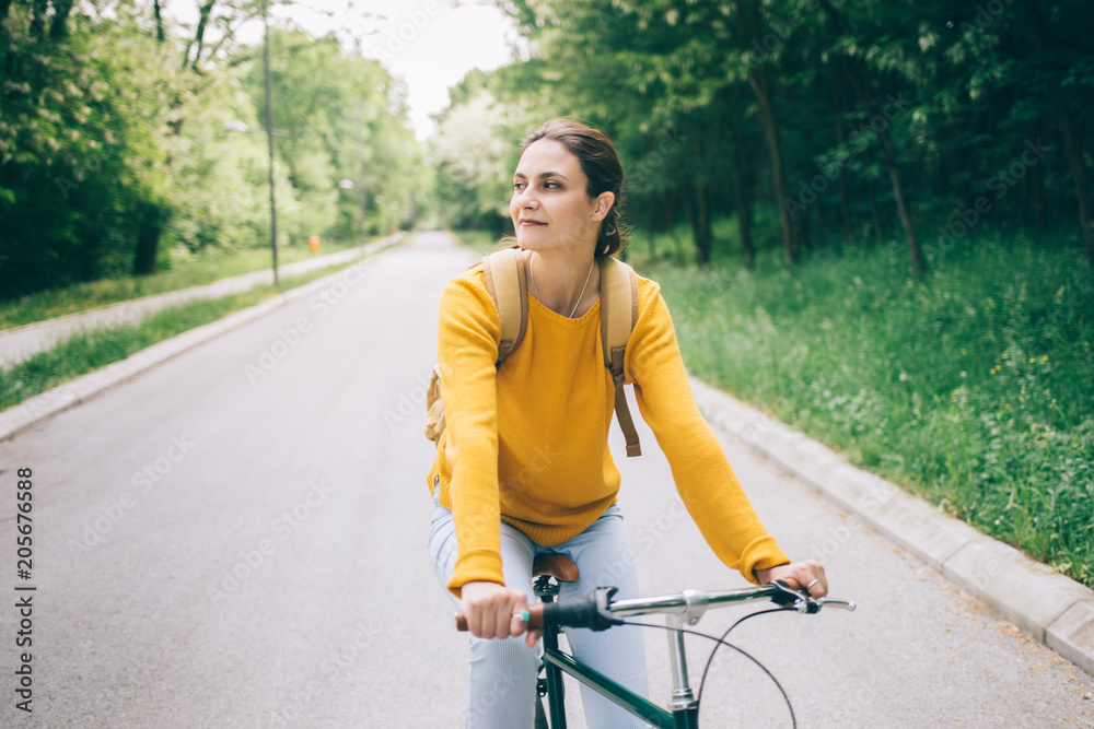 Young woman riding bicycle in the park