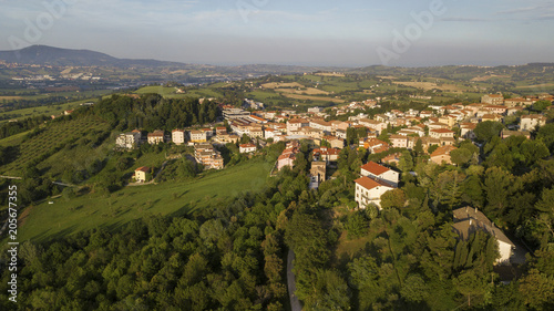 Aerial view of the countryside between Tuscany and Marche in Italy during a beautiful sunny day in summer. The fields are cultivated and the hills are rich in trees and forests.