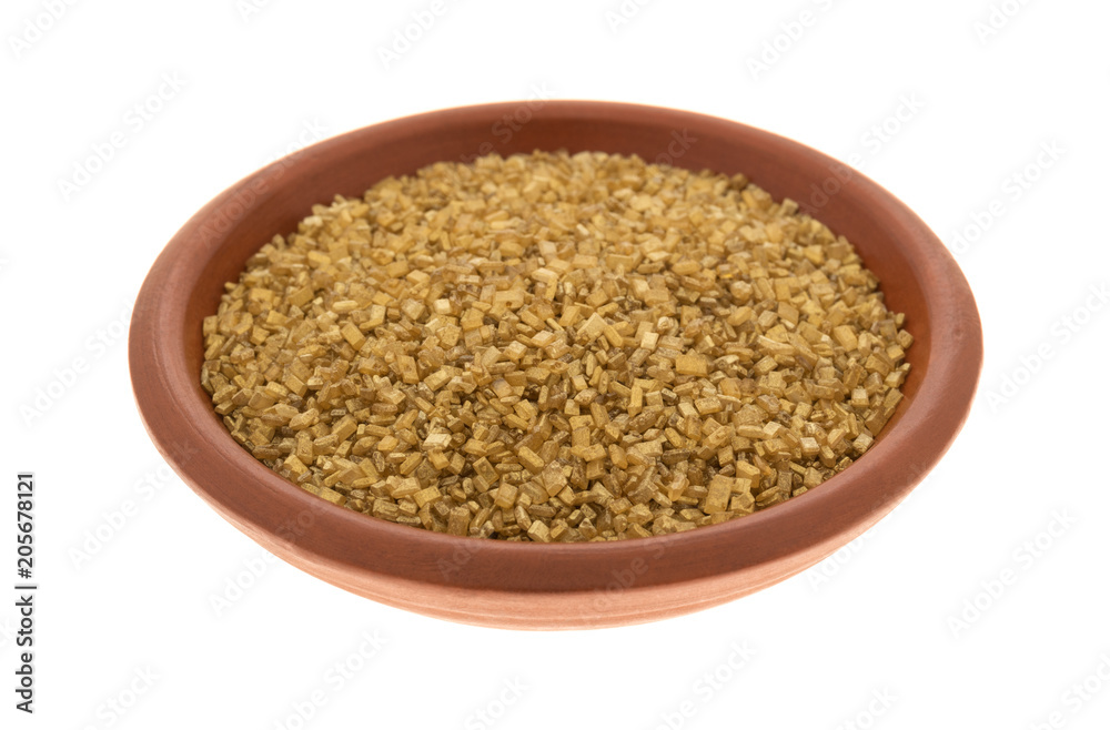 Bowl of gold sugar on a white background. Bowl of gold sugar on a white background.