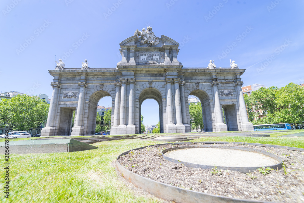 Obraz premium Puerta de Alcala is a one of the Madrid ancient doors of the city of Madrid, Spain. It was the entrance of people coming from France, Aragon, and Catalunia. It is a landmark of the city.