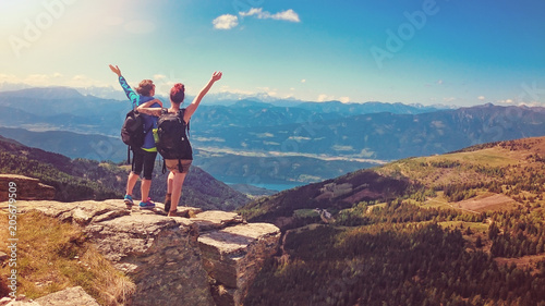 two women standing on the top of a mountain with wonderful view