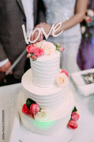 Beautiful multi-tiered wedding cake with the inscription love