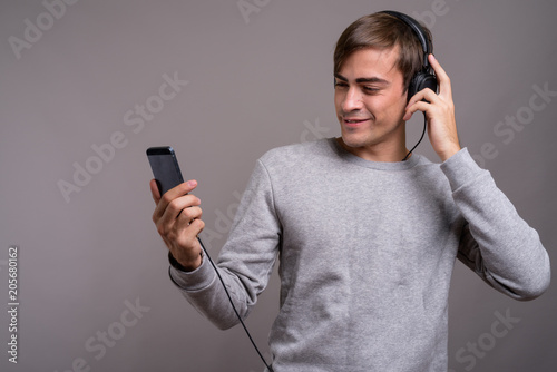 Young handsome man listening to music and ready for gym against  © Ranta Images
