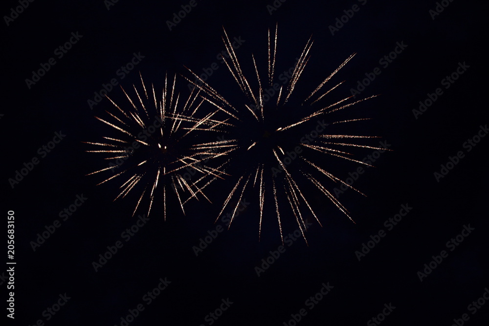The sparks of the fireworks high in the night sky. The sparks of the fireworks high in the night sky.