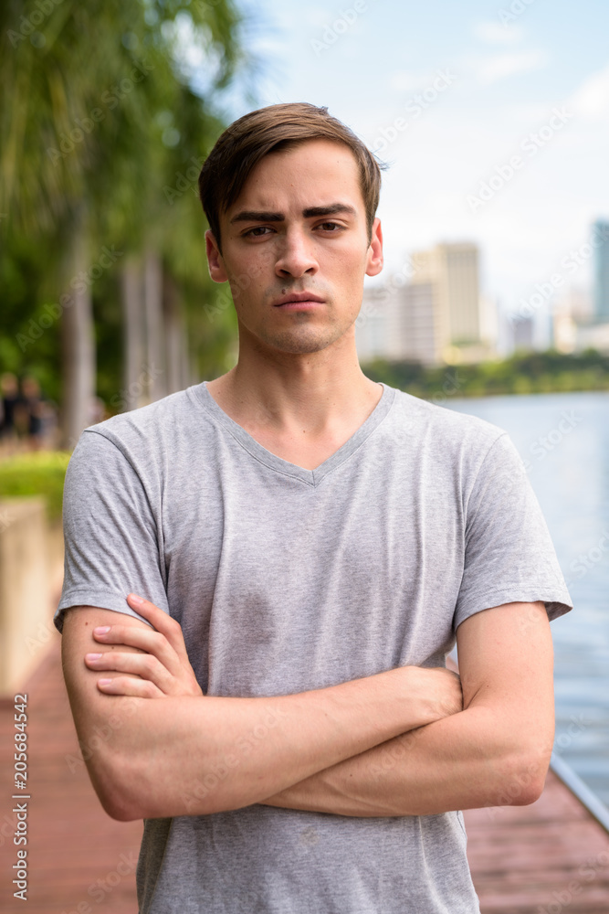 Fototapeta premium Young handsome man relaxing at the park