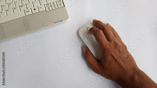 flat lay or top view footage working man hand with notebook using wireless mouse at white