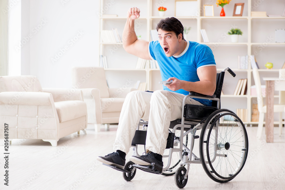 Disabled man watching sports on tv