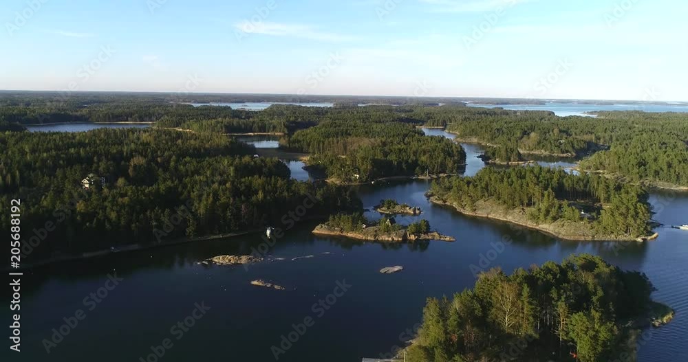 Finnish islands, C4k aerial view over the archipelago, outside skaldo, on a sunny spring sunset evening dawn, in Baggo, Uusimaa , on the gulf of Finland Finnish islands, C4k aerial view over the archipelago, outside skaldo, on a sunny spring sunset evening dawn, in Baggo, Uusimaa , on the gulf of Finland