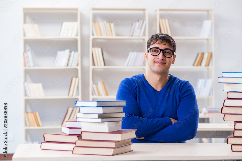 Male student preparing for exams in college library Male student preparing for exams in college library