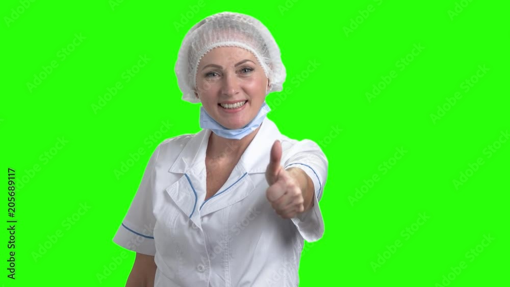 Happy medical worker showing thumb up. Pretty smiling lady doctor gesturing thumb up on Alpha Channel background. Happy medical worker showing thumb up. Pretty smiling lady doctor gesturing thumb up on Alpha Channel background.