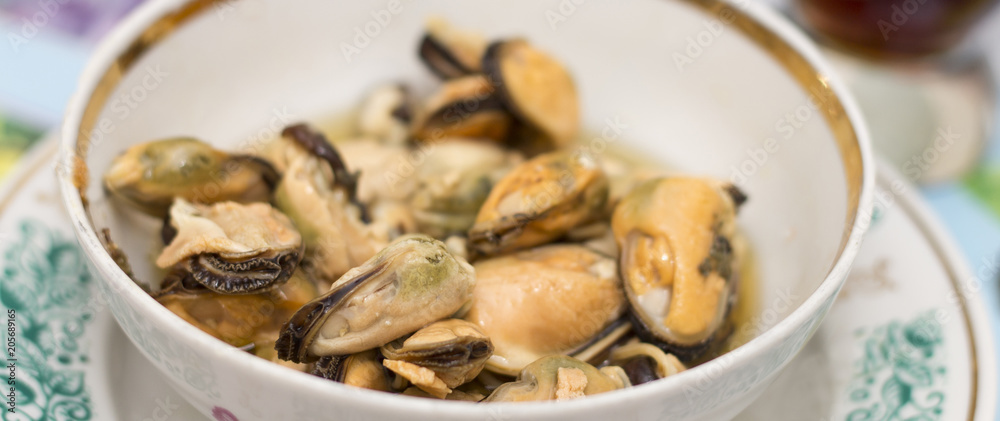 Tasty oiled pickled mussels iin a plate on the table Tasty oiled pickled mussels iin a plate on the table