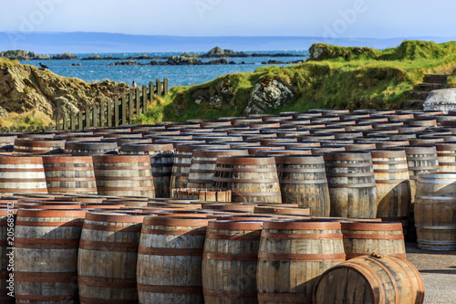 Scotch whisky / whiskey barrels lined up by the seaside on the Island of Islay, Scotland, UK