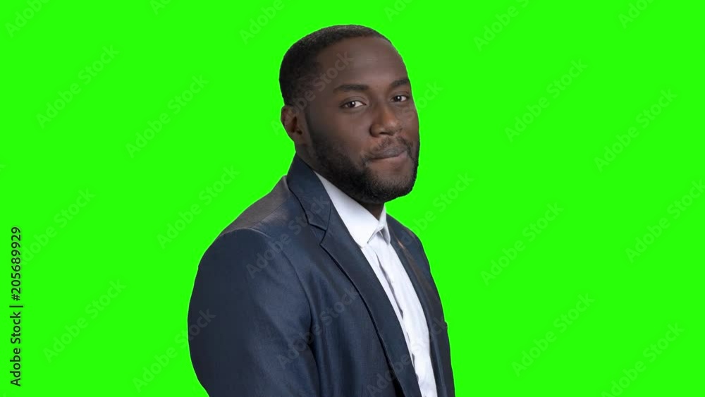 Smiling macho-man on green screen. Portrait of sexy afro-american businessman is flirting on Alpha Channel background. Invitation for a date. Smiling macho-man on green screen. Portrait of sexy afro-american businessman is flirting on Alpha Channel background. Invitation for a date.