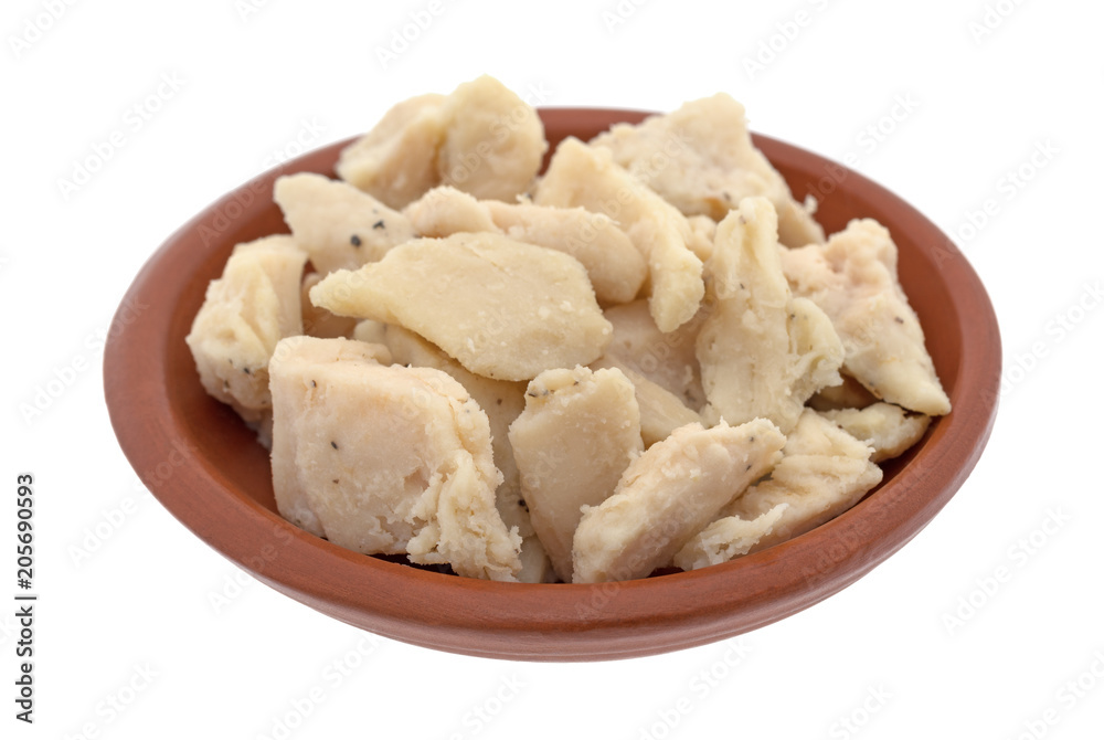 Chicken breast chunks in a small bowl isolated on a white background. Chicken breast chunks in a small bowl isolated on a white background.