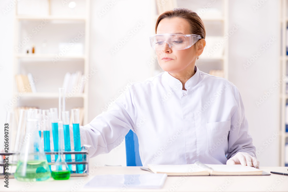 Woman chemist working in hospital clinic lab Woman chemist working in hospital clinic lab