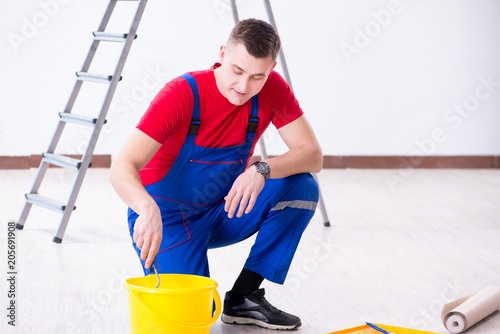 Male painter preparing for painting job at construction site