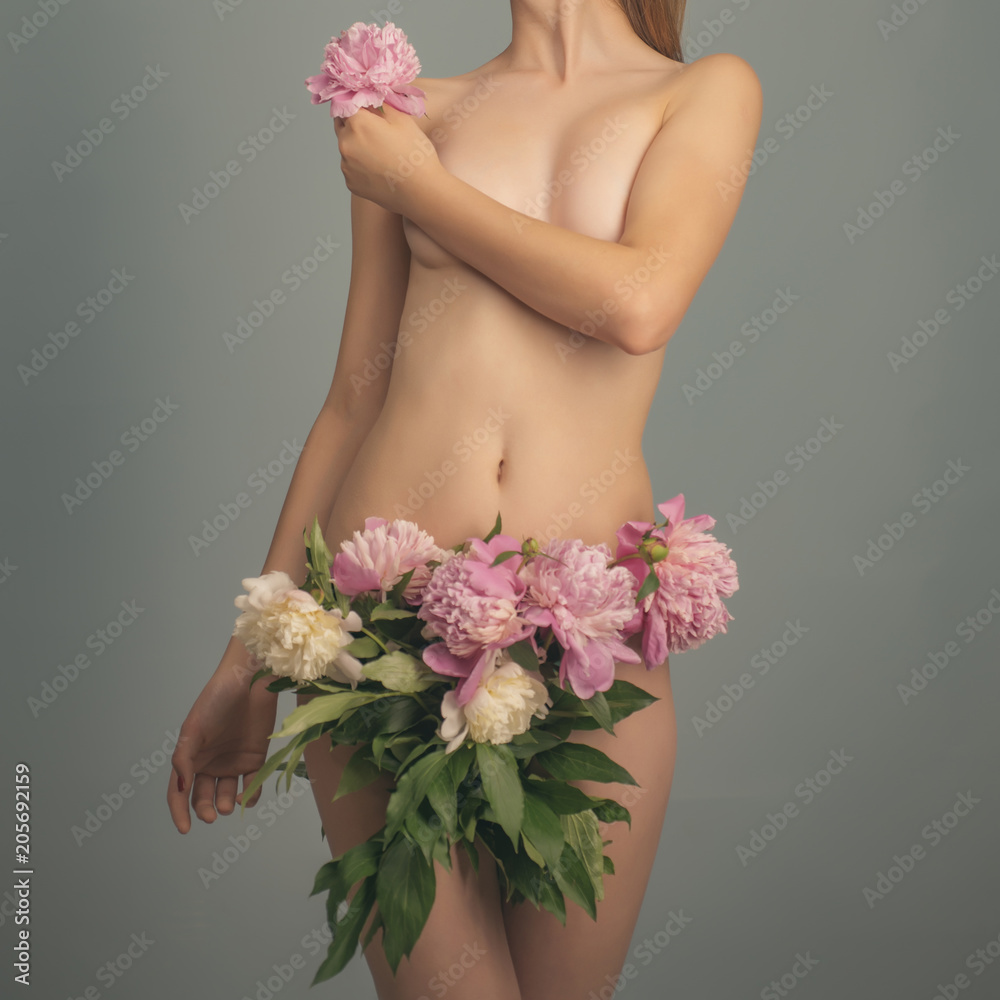 Girl with flowers. Sexy lingerie, fashion sexy concept. Beautiful woman  with pink petals on hips. Bikini area like flower. Nude body fine art.  Perfect body line. Young nude woman holding flower foto